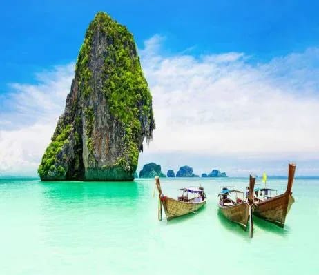 Longtail boats beneath a limestone rock, Krabi
